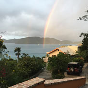 The House as seen from the driveway with a rainbow over the Bay
